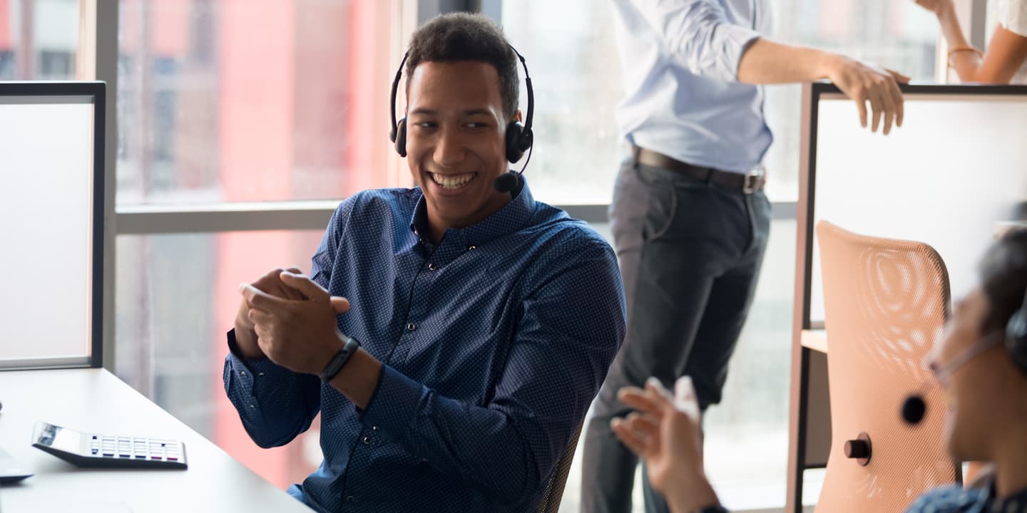 call center worker laughing with colleague