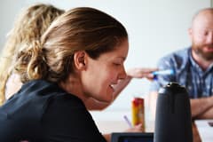 Photograph of Allison Torpey's side profile as she works on a collaborative exercise with other Propeller employees. Allison Torpey is Propeller's Denver managing director.