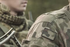 Close up of soldiers wearing camouflage fatigues lined up. The soldiers' faces are obscured.