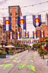 Several rows of Colorado state flags hanging over the street in Larimer Square in Denver, Colorado