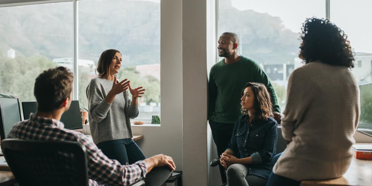 Diverse designers discussing a project together in their office