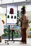 Shopper using kiosk to look at clothes retail