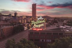 Image of downtown Portland, OR and the famous White Stag sign during sunset. Image by Justin Shen via Unsplash.
