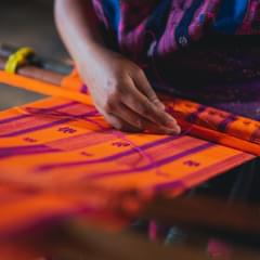 Mexican woman weaving tapestry using traditional weaving techniques. Photo by Los Muertos Crew via Pexels.com