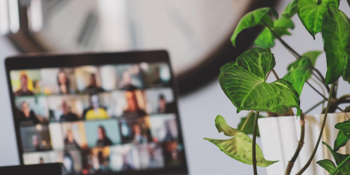 Image of a laptop with several images of people joining a video meeting. Photo by Sigmund Agency via Unsplash.