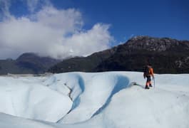 Chile patagonia carretera austral exploradores glacier guide walking onto left hand edge of image
