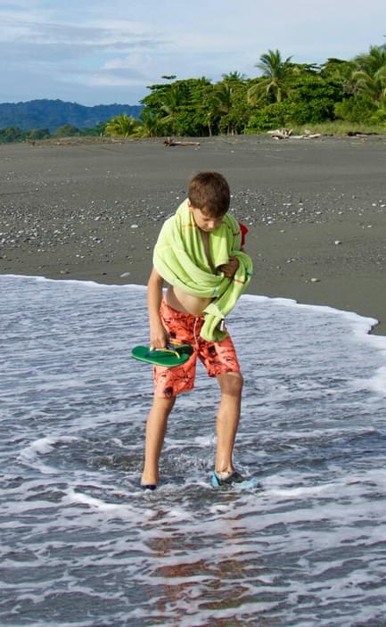boy walking beach osa peninsula