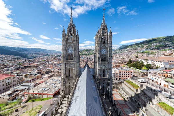 Ecuador quito view of the towers of the basilica in quito ecuador with the city visible in the background