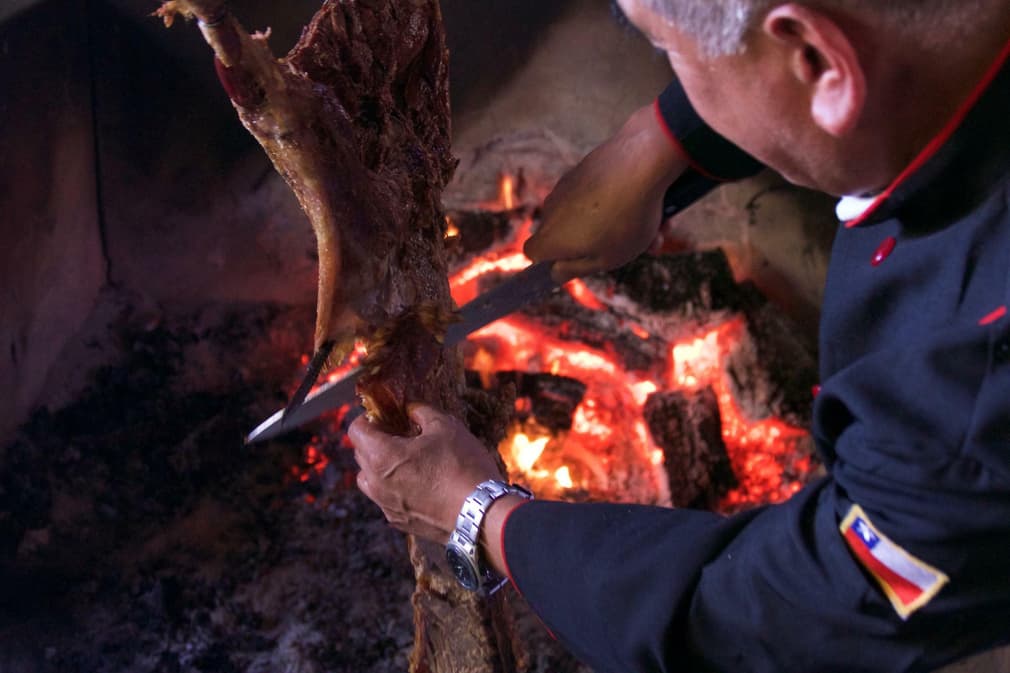 Chile patagonia carretera austral carving lamb asado estancia punta del monte coyhaique c pura aventura thomas power