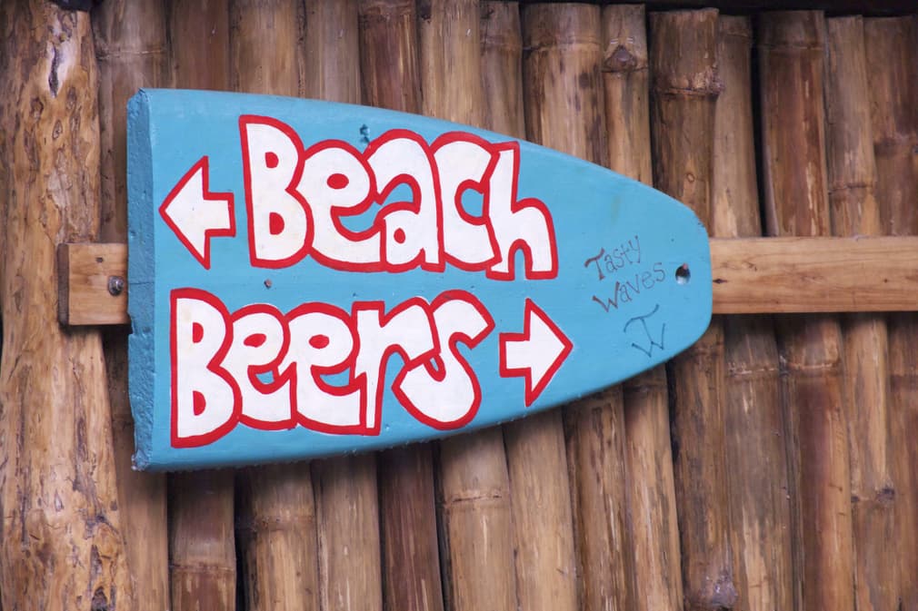 Costa rica caribbean beach beers signpost