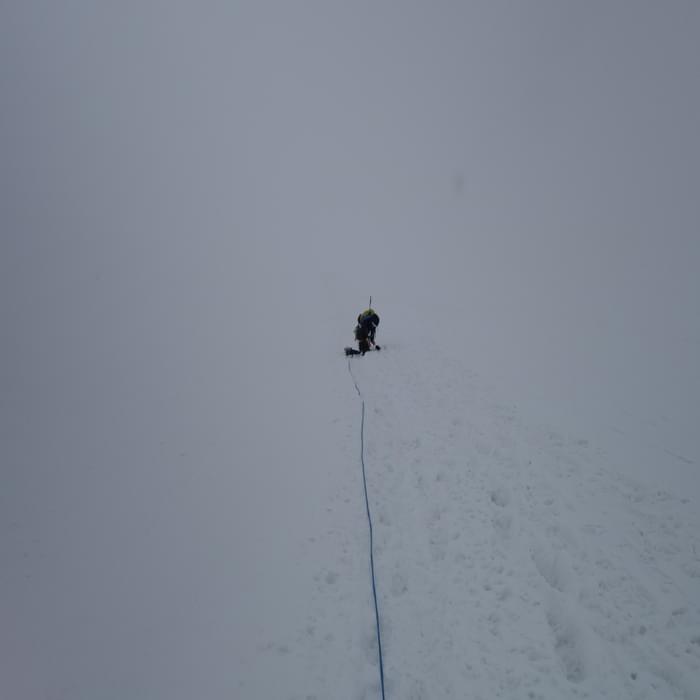 Caroline finally succumbed to needing to retie her shoelaces. The snow was now coming in and we were hurrying to make it to the last cablecar down from the Breithorn