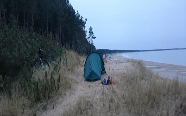 Campsite by the sea on a winter ride of the Moray Trail