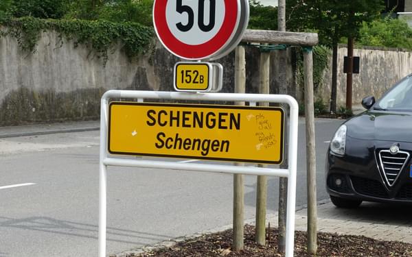 City limit sign for Schengen (with graffito requesting visas)