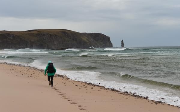 Lily running through Sandwood Bay, Scotland. Photo by Chris Councell.
