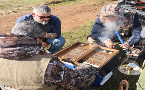 Hunters indulging in backgammon and shisha