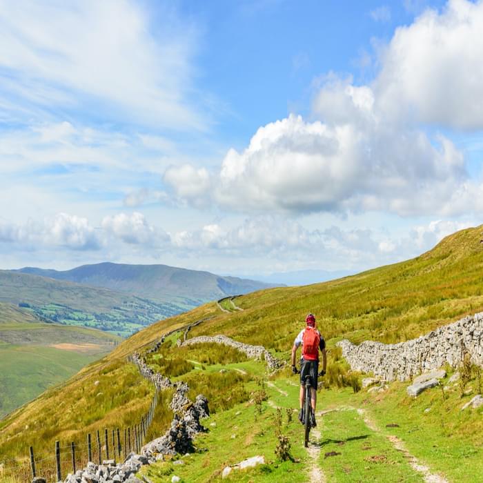 Jon Sparks on the 'Driving Road' during our Pennine Bridleway ride, with Dentdale appearing below, Middleton Fell behind and the Coniston Fells on the skyline.