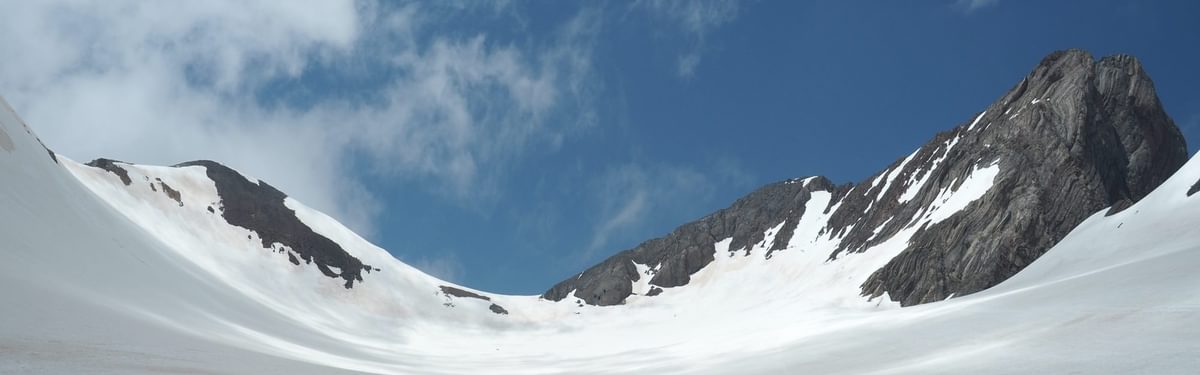 An overview of the Vignemale peak, the Ossoue glacier and the three Russell caves in the middle