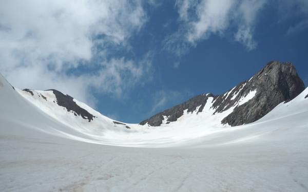 An overview of the Vignemale peak, the Ossoue glacier and the three Russell caves in the middle
