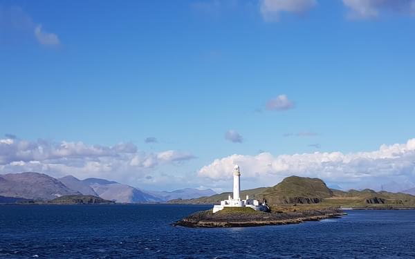 The lighthouse on Eilean Musdile from the ferry crossing to Mull