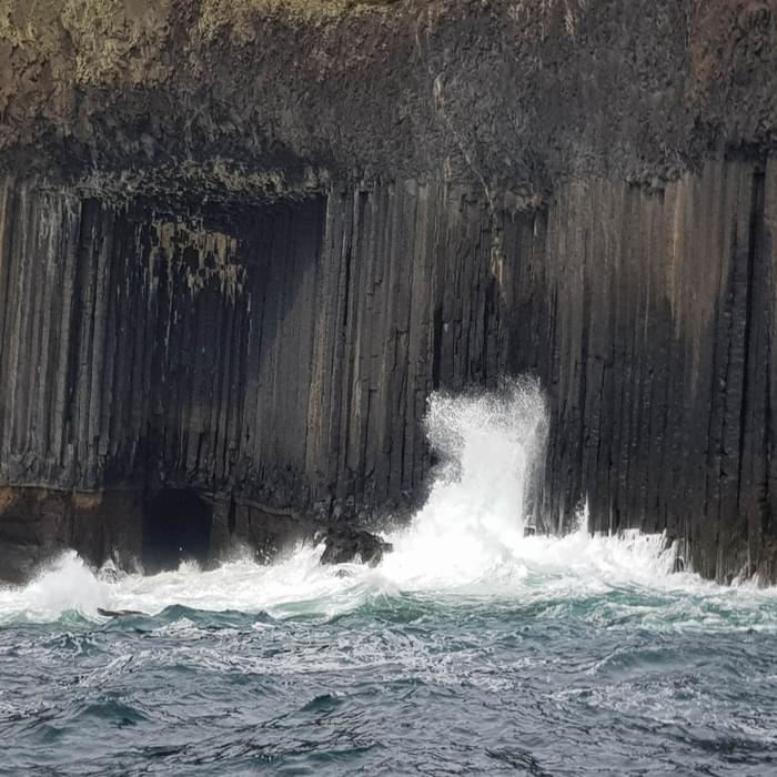Waves crash against the basaltic columns of the Isle of Staffa