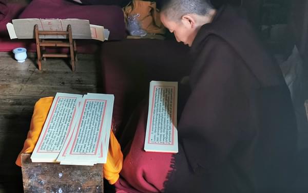 A monk reading prayers at Thubtan Chholing Monastery in Junbesi