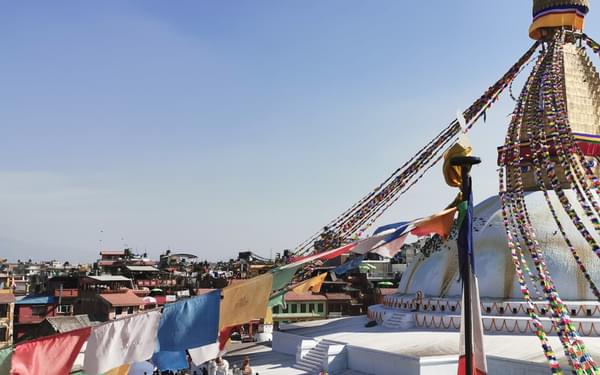 Prayer flags draped from a stupa
