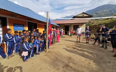 A group photo in front of the finished school
