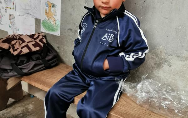 One of the children at Kinja wearing their new uniform