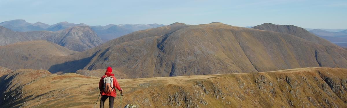 A mountain, a ridgeline, and a man in a red jacket – 'unoriginal and lacking spark' but just right for a guidebook. Stob Ghabhar