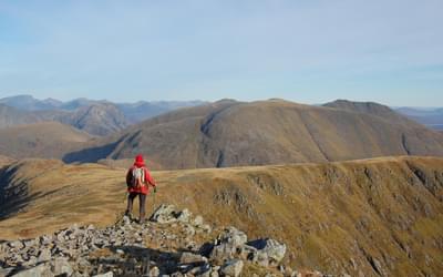 A mountain, a ridgeline, and a man in a red jacket – 'unoriginal and lacking spark' but just right for a guidebook. Stob Ghabhar