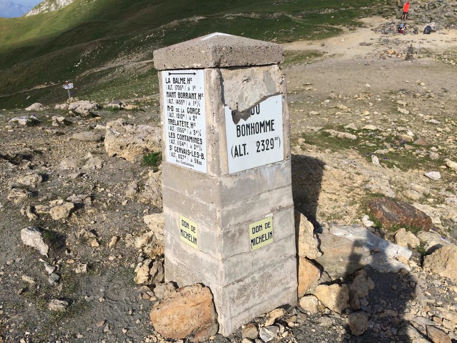 A Chipped Sign Marking The Col Du Bonhomme