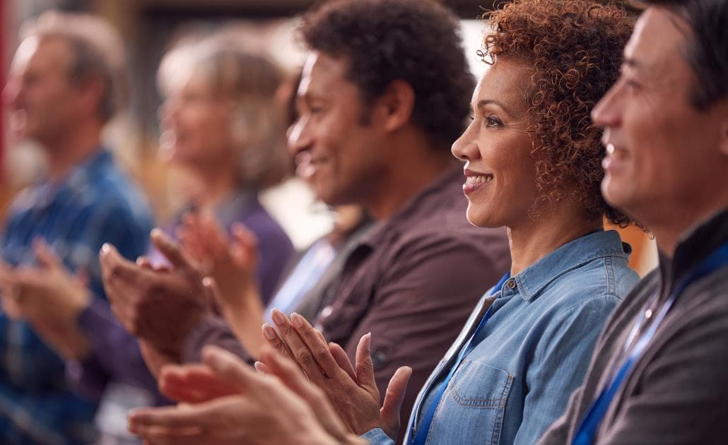 Business people clapping at conference