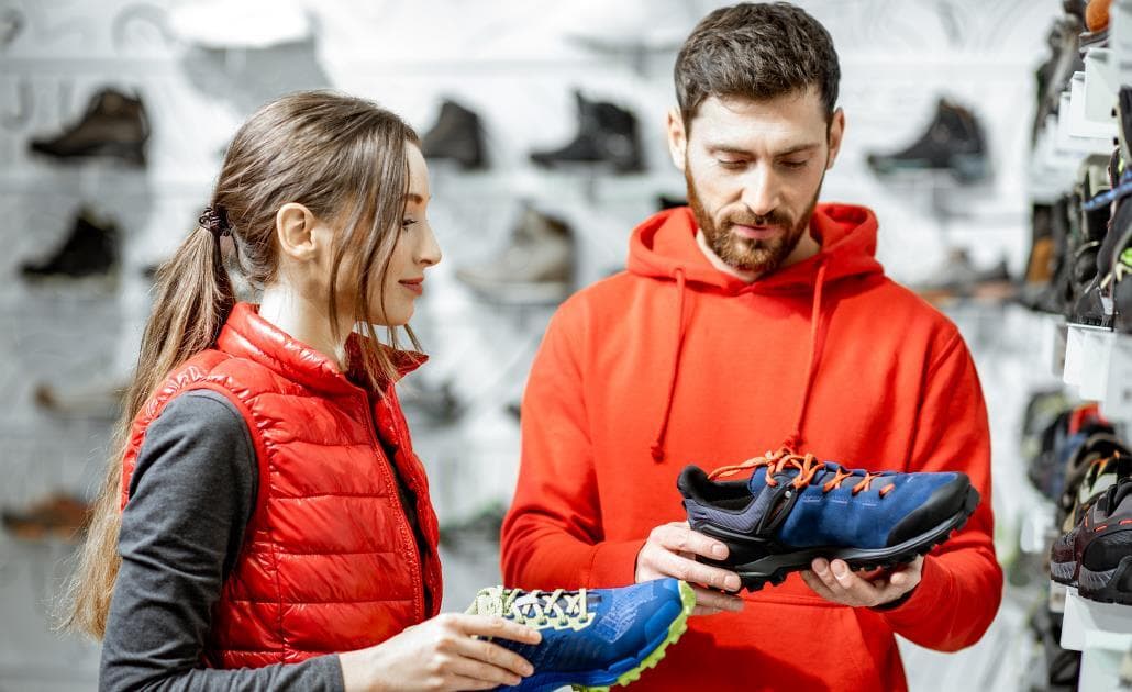 Man and woman comparing shoes