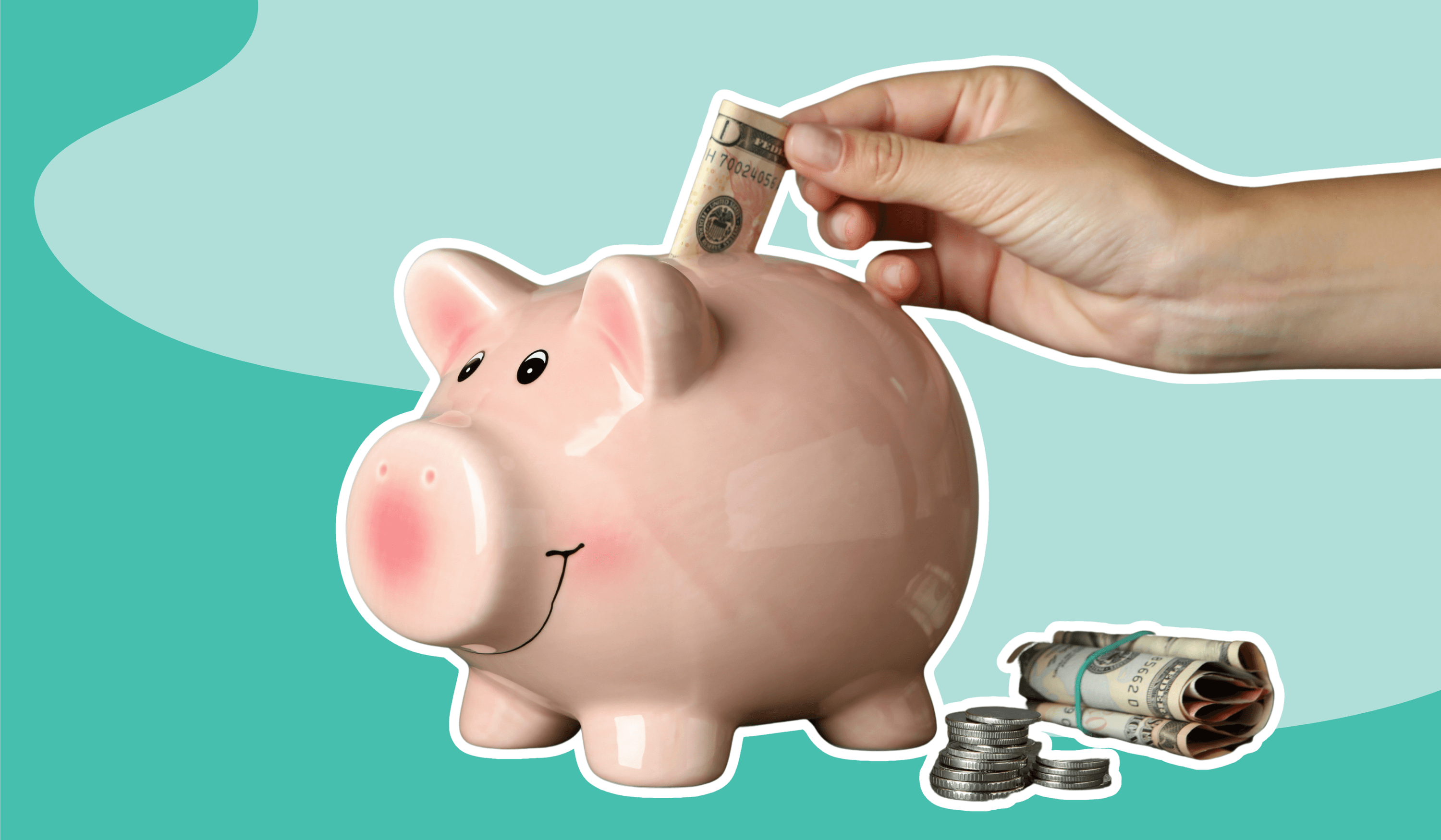 Hand putting money in piggy bank