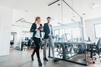 Business people walking and talking discussing ideas in the office