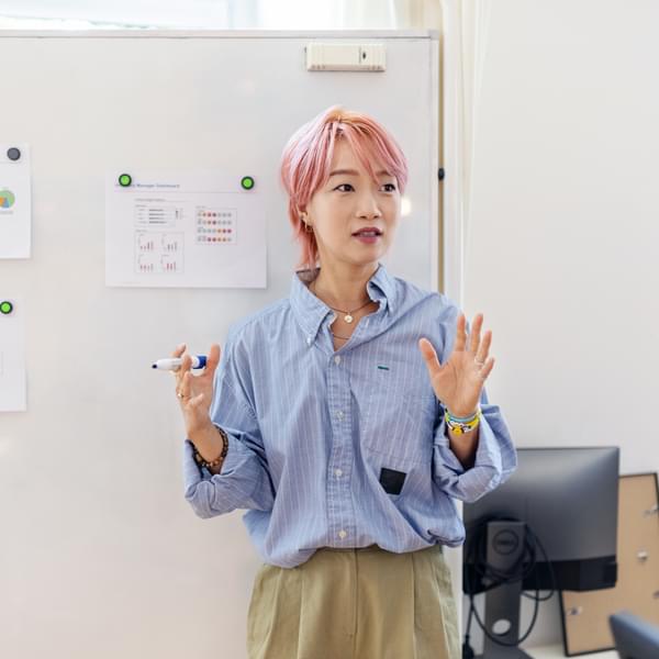 Female professional sharing new marketing ideas with team at office