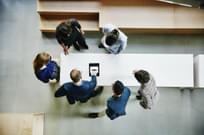 Business colleagues discussing project on a digital tablet