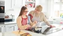 mother and daughter cooking on induction stove