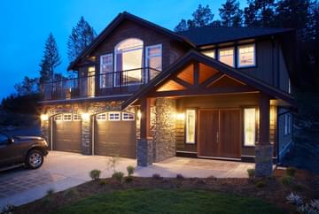 Modern house with car parked on drive, dusk