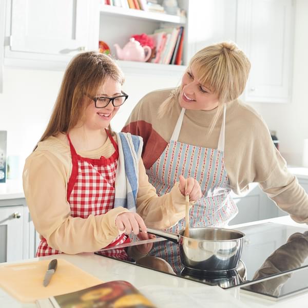 mother and daughter cooking on induction stove