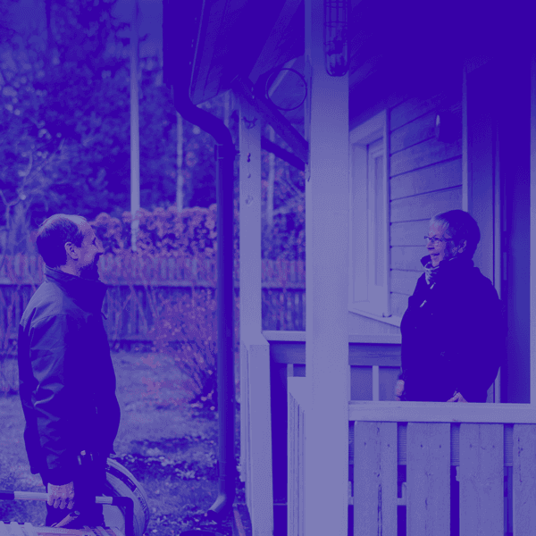 Contractor greeting customer on the porch of the house