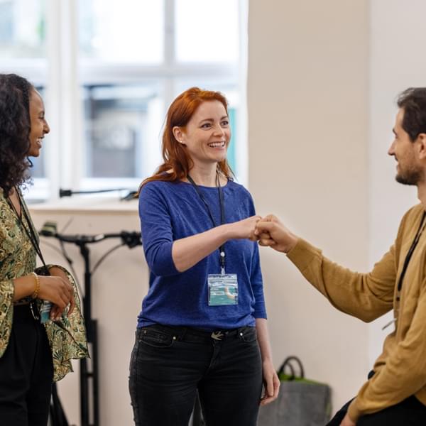 Multiracial business people greeting each other with fist bump.