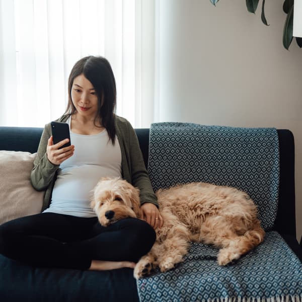 Woman on couch with mobile phone