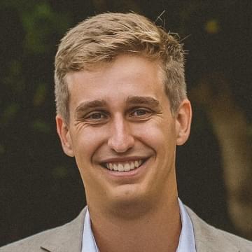 Close-up portrait of Justin Miller standing outside.