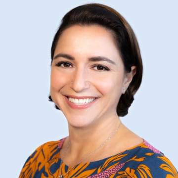 Close-up portrait of Jennifer Ignacio on plain background.