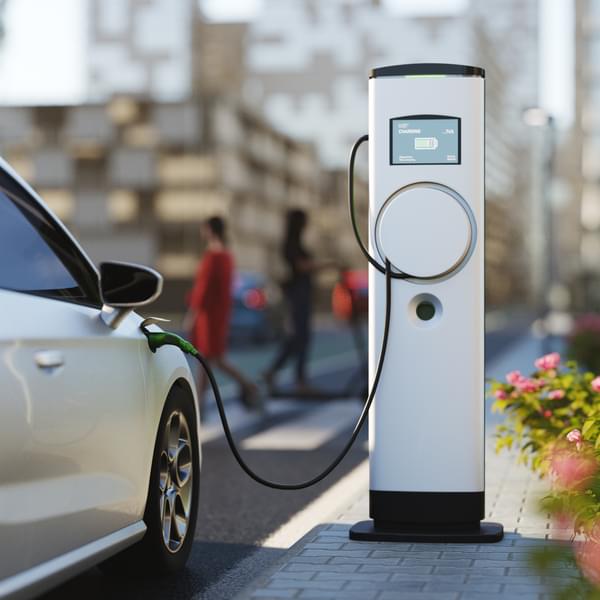 An electric vehicle at a charging station in the city.
