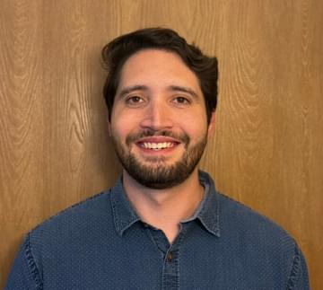 Professional headshot of Alex Opipari