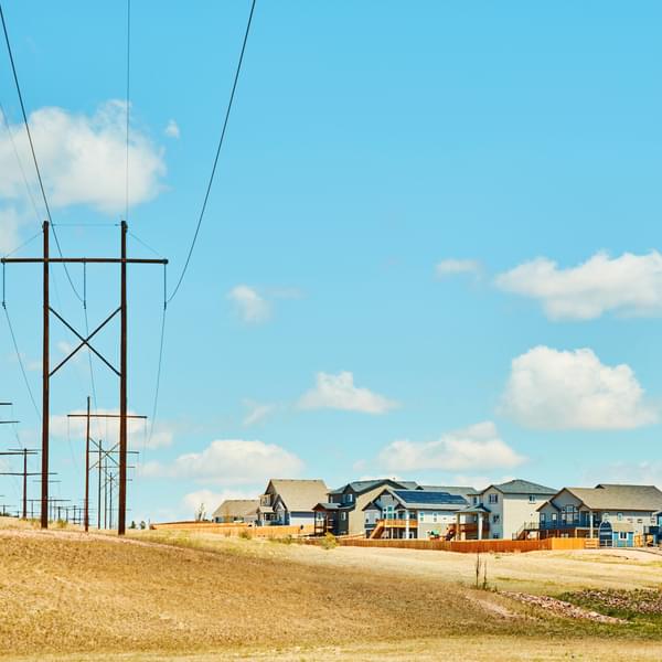 Modern new homes sharing the environment with power lines, some homes have solar panels. Midwest USA. Summertime.