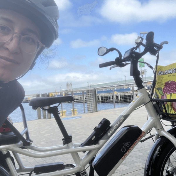 Resource Innovations employee posing in front of her electric bicycle