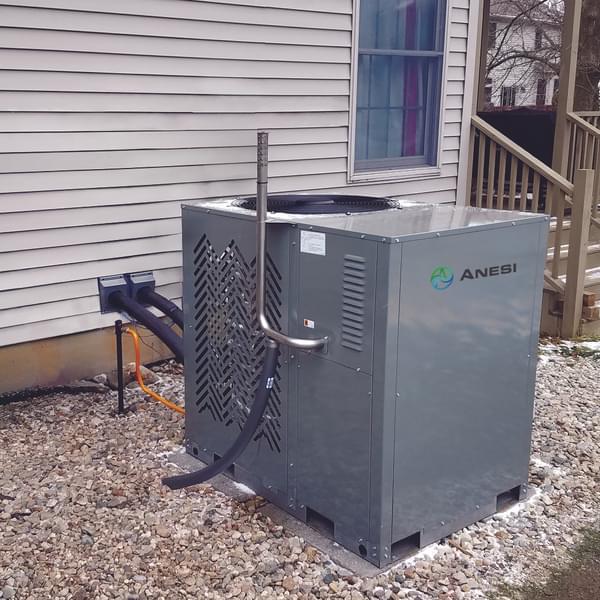 SMTI gas heat pump residential installation with view of home